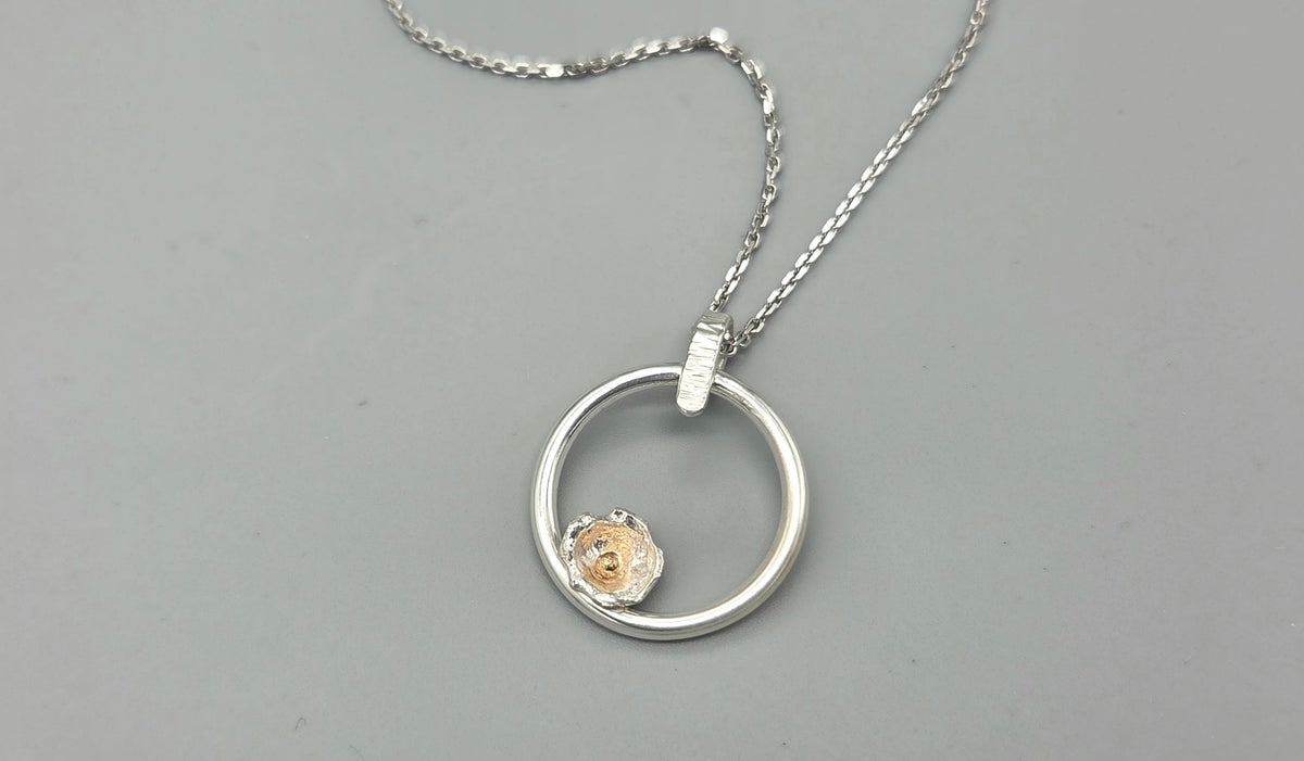 Mixed metal nature inspired pendant with flower bud