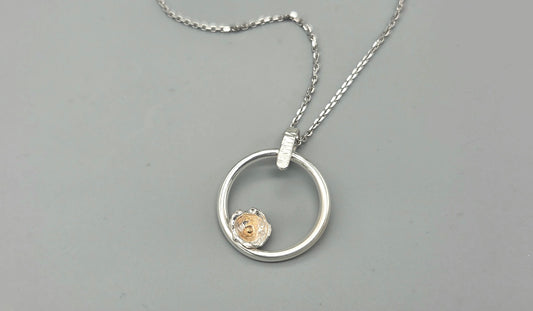 Mixed metal nature inspired pendant with flower bud