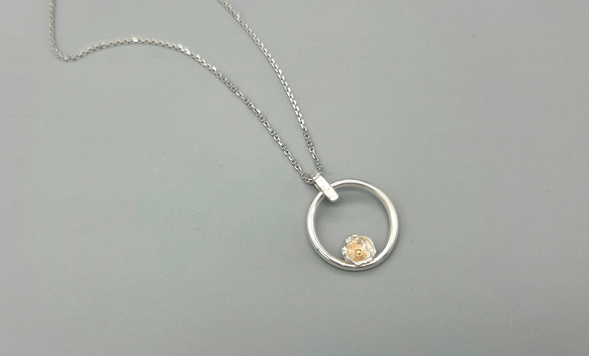Mixed metal nature inspired pendant with flower bud