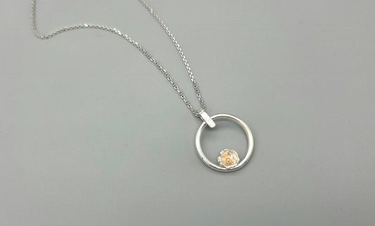 Mixed metal nature inspired pendant with flower bud